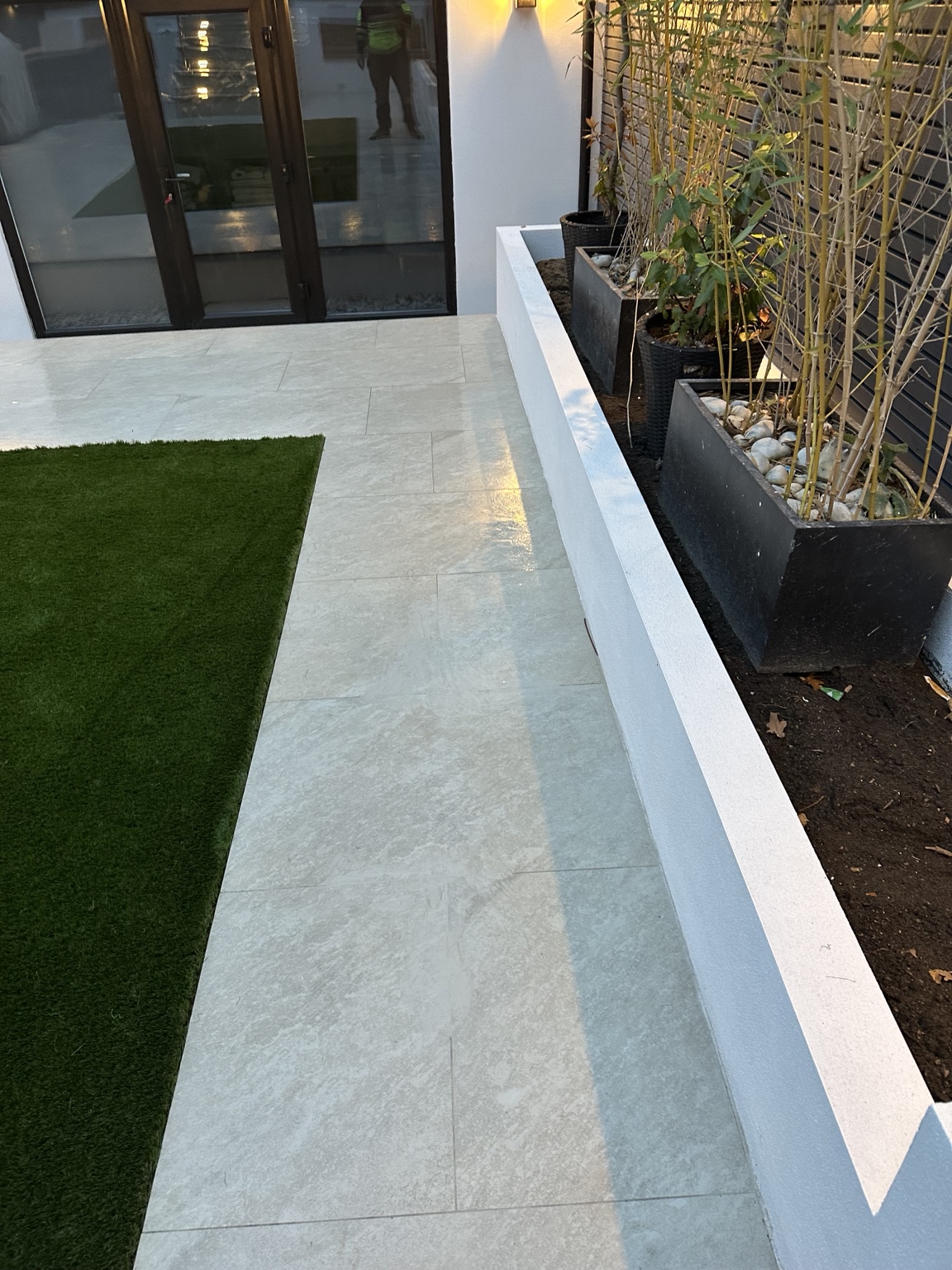 Detail of porcelain paving and raised planting beds
